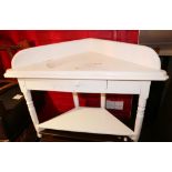 A white painted two-tier corner washstand, 42" wide x 21" deep x 32" high