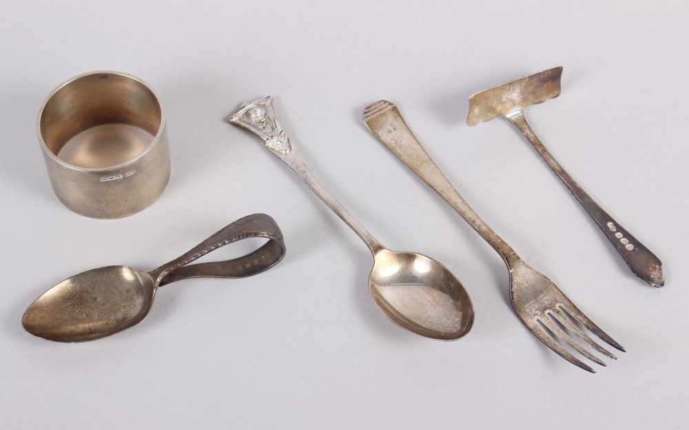 A child's silver spoon and pusher, a silver napkin ring, a silver fork and a silver spoon, 3.3oz