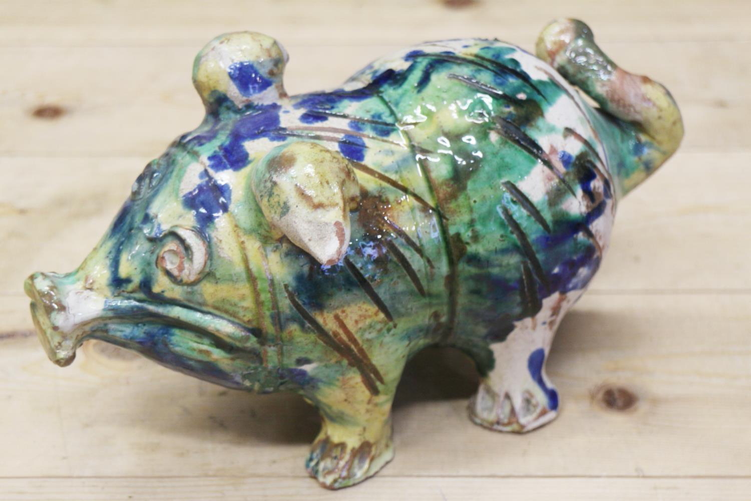 An Italian majolica pig with splashed decoration, 10" long