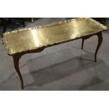 An Italian carved cherrywood shape top low coffee table with brass two-handled tray top, on cabriole