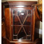 A walnut corner hanging cabinet enclosed lattice glazed door, 31" wide x 19 1/2" deep x 29" high