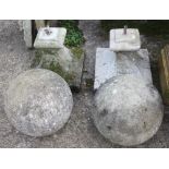 Two cast stone balls, on splayed square stands, 26" overall