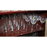 A pair of red wine glasses with twisted relief design, a set of six similar white wine glasses and