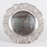 A circular silver dish with embossed Rococo border, 9" dia, 8.1oz troy approx