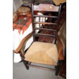 An oak ladder and spindle back armchair with rush seat and an oak and elm seat armchair (for