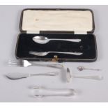 A silver part christening set (missing knife), a baby's food pusher, a fork, a pair of sugar
