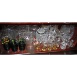 A quantity of decanters, jugs, coloured glass drinking vessels and other items