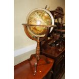 A terrestrial globe, on turned wooden stand and tripod supports