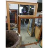 A pine rectangular wall mirror with bevelled plate, 27 1/2" x 19 1/2", and a light oak framed wall