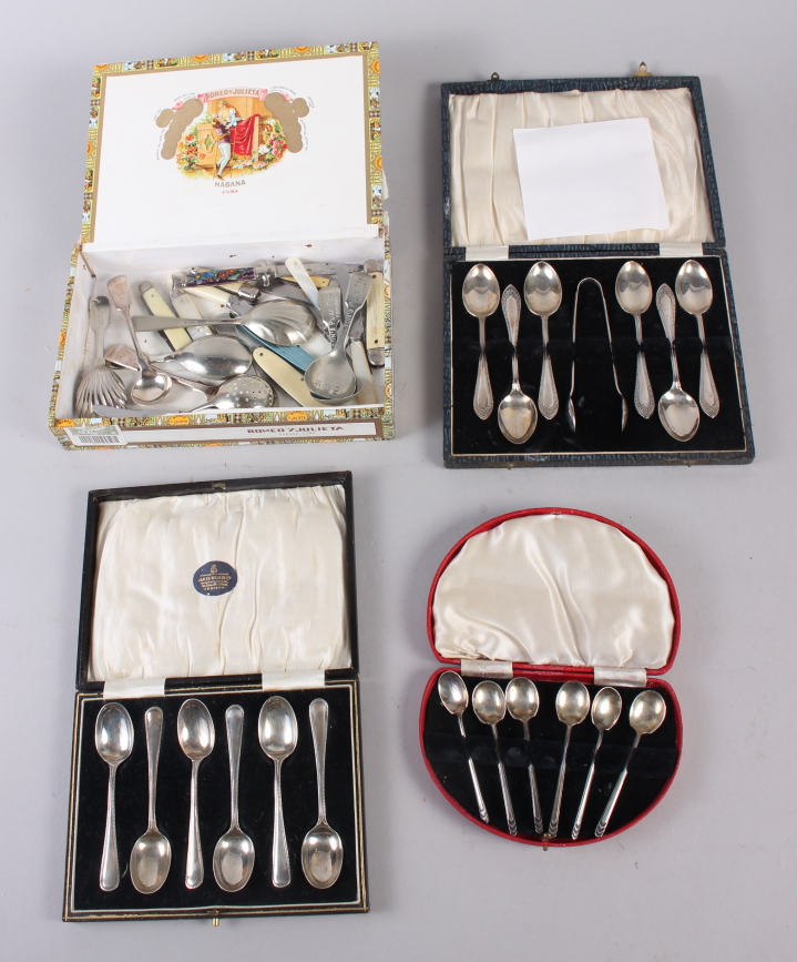 A cased set of six silver teaspoons, another set of teaspoons, a silver plated pair of sugar