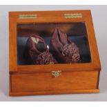 An infant's pair of silk and embroidered shoes, in display case, 7 1/4" wide