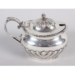 A silver mustard pot with embossed decoration, 3.1oz troy approx