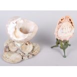 A shell cameo, depicting The Three Graces, on metal stand , 7 1/4" high, and a shell centre piece, 6