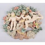A studio pottery panel of Adam, Eve and the serpent, 15" high, and a studio pottery charger with