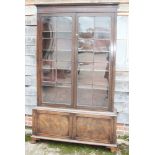 A late 19th century mahogany bookcase of Pepysian design, the upper section enclosed lattice