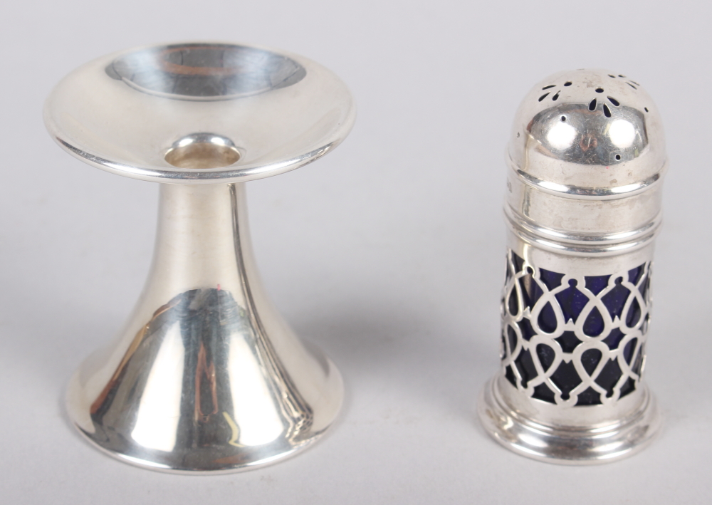 A silver pepperette with lattice work decoration and a silver candle holder, 3.1oz troy approx