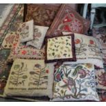 Seven embroidered cushions, various, and a crewel work cushion