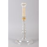 An antique spiral fluted glass vase with floral rim, 16 1/2" high, and a glass candlestick, now