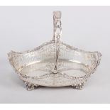 A James Dixon & Son silver swing handle bread basket with pierced decoration, on four scrolled feet,