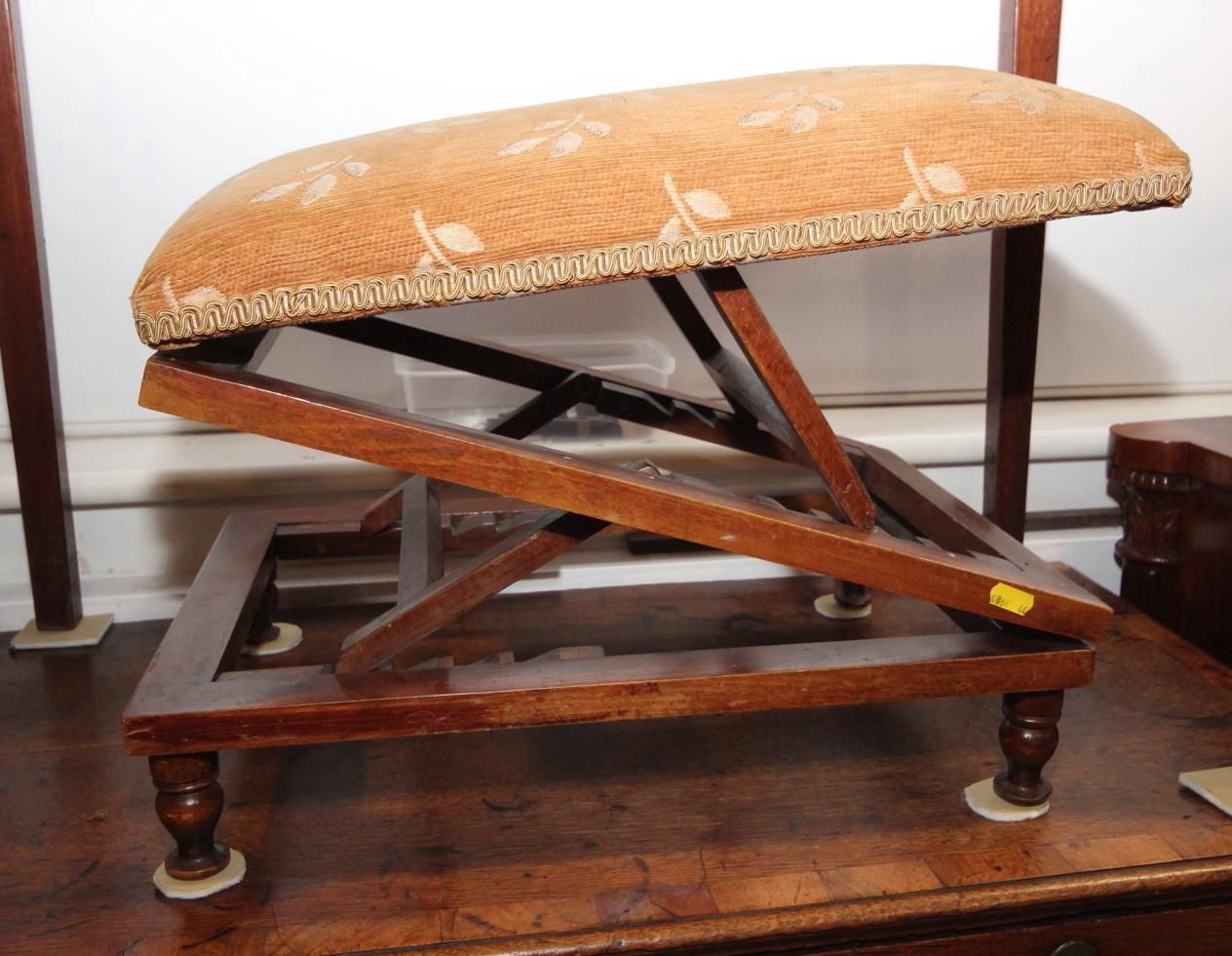 An early 20th century rectangular upholstered footstool, on double ratchet supports