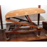 An early 20th century rectangular upholstered footstool, on double ratchet supports