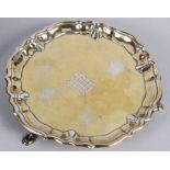 A cast silver gilt card tray with engraved coat of arms, on three supports, 8.6oz troy approx