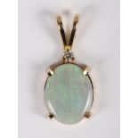 A diamond and opal pendant mounted in yellow metal, stamped 14k
