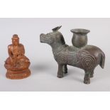 A Tibetan carved wood buddha, 5 1/4" high, and a Chinese cast bronze candlestick, formed as a