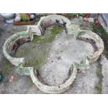 A cast stone quatrefoil-shaped planter, 54" x 51" approx