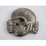 A metal WWII German SS skull for peaked cap.