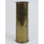 A WWI brass shell case dated 1916 having 'trench art' hammered over lip,