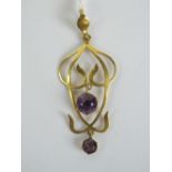 A 9ct gold art nouveau floral pendant having two round cut amethysts upon, stamped 9ct, 4.