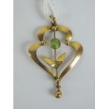 A 9ct gold Edwardian pendant of floral form having round cut peridot upon, stamped 9ct, 3.