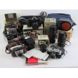 A quantity of camera equipment including a Canon A1 SLR camera with 35-70mm zoom lens,