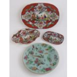 Four assorted Oriental plates comprising three bearing the same hand painted floral design being