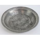 A heavy pewter dish having initials DC to base, measuring 31.5cm dia and weighing 1.634kg.