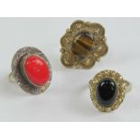 Three silver and hard stone rings; tigers eye size T,