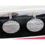 A pair of HM silver cuff links of oval form having engraved pattern upon, hallmarked for Birmingham,
