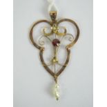 A 9ct gold Edwardian floral pendant having central round cut garnet with pearl suspended below and