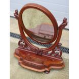 A good mahogany toilet mirror, the oval mirror raised on shaped and pierced supports,