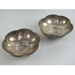 A pair of HM silver bonbon dishes each raised over three clam shell feet,