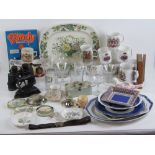 A basket containing a quantity of assorted ceramics, glassware, vintage flat iron, girl guide belt,