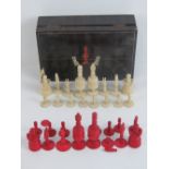 A 19th century ivory chess set in faux rosewood lidded box painted with chess pieces upon,
