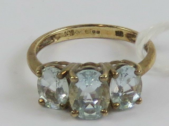 A 9ct gold and aquamarine three stone ring,