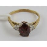 A 9ct gold red and white stone ring, hallmarked 375, size O, 2.2g.