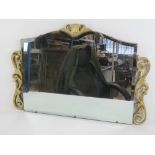 A hanging shaped and bevelled edge over mantle mirror having 'gilded' frame, 74cm wide.