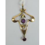 A 9ct gold art nouveau pendant of floral form having two round cut amethysts upon, stamped 9ct, 5.