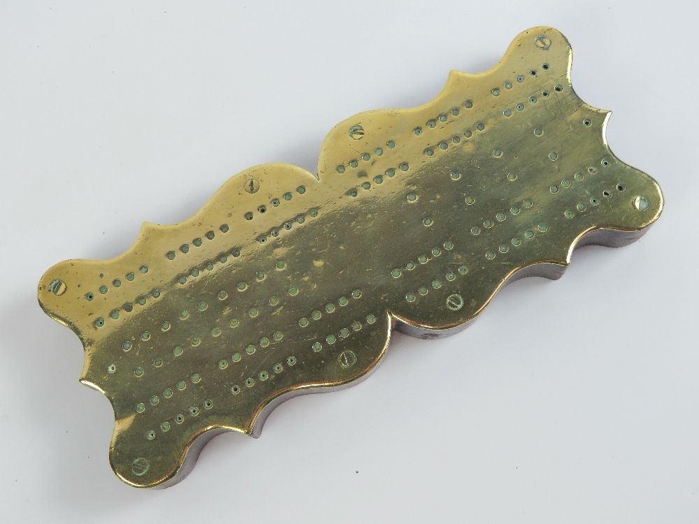 A brass cribbage board mounted on shaped mahogany base. 26cm in length. - Image 2 of 2