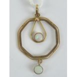 A delightful 9ct gold Edwardian pendant of geometric form having two round opal cabachons upon an