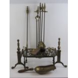 A quantity of brass fireside equipment including freestanding companion set, footman, fire dogs,